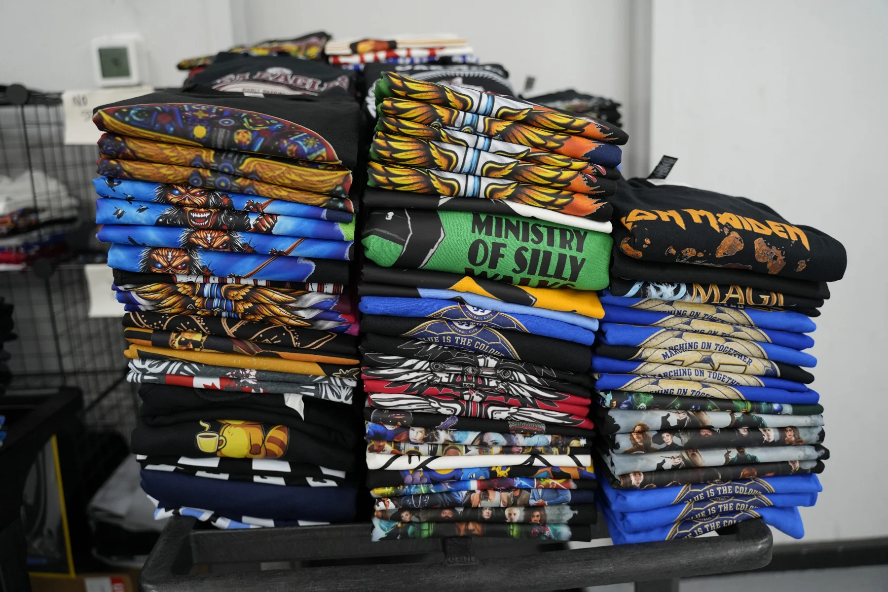Stacks of finished printed shirts in the shop